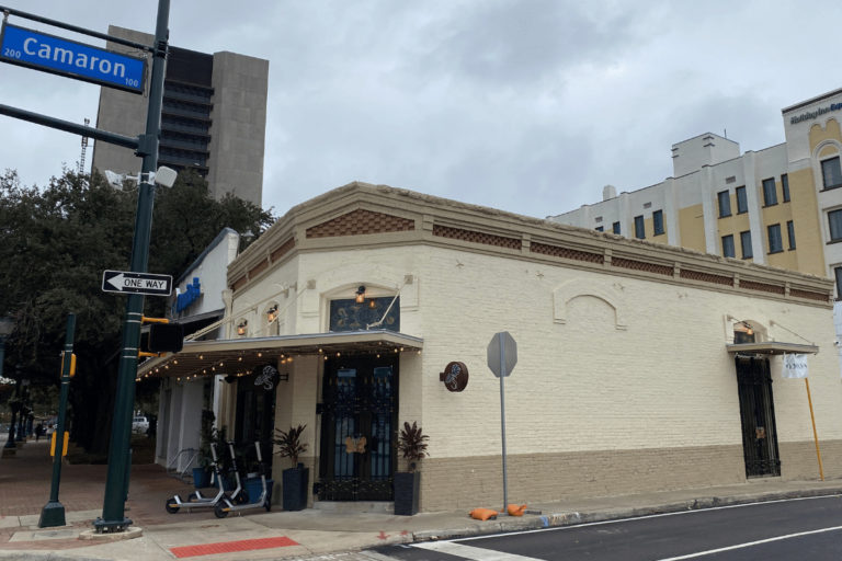 Street view of historic building at corner of Houston Street and Cameron Street.